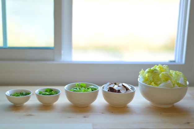 Spring onions, celery, celery, mushrooms, lettuce in a bowl, prepared as a vegetable for cooking