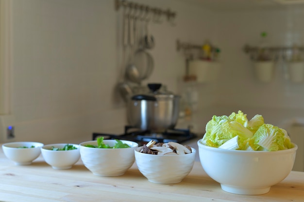 Photo spring onions, celery, celery, mushrooms, lettuce in a bowl, prepared as a vegetable for cooking