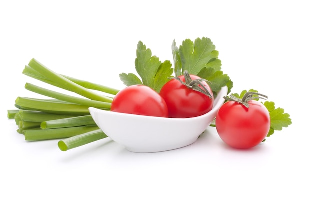 Spring onions and cherry tomato in bowl