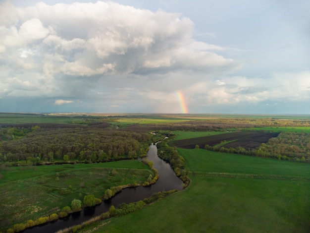 Spring rainbow landscape after rain by the river aerial photo