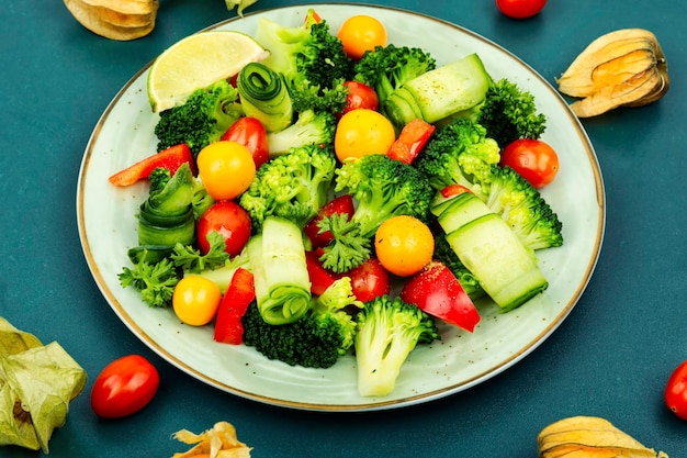 Spring raw salad decorated with physalis