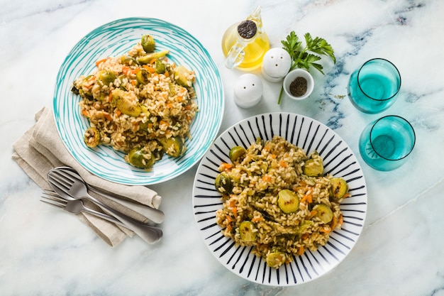 Photo spring risotto on a marble table with spices and olive oil