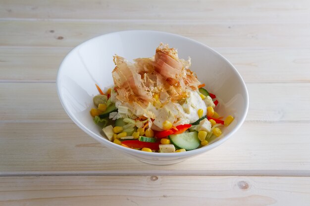 Spring salad with cucumber, bell pepper, corn and tuna chips