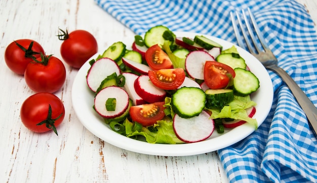 Spring salad with tomato, cucumbers and radish