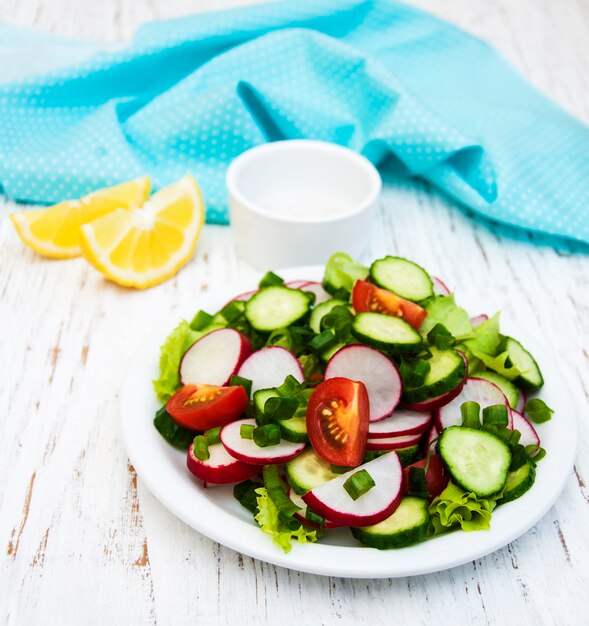 Spring salad with tomato, cucumbers and radish