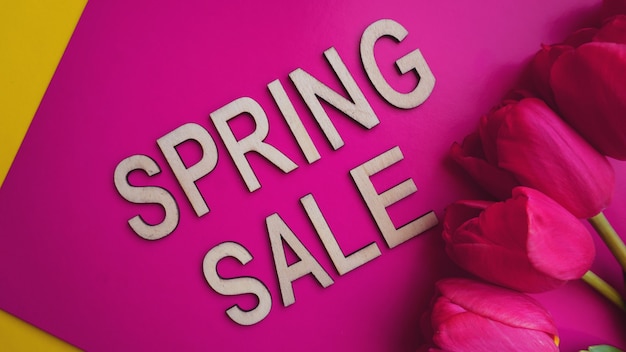 Photo spring sale banner with pink tulips on colorful background