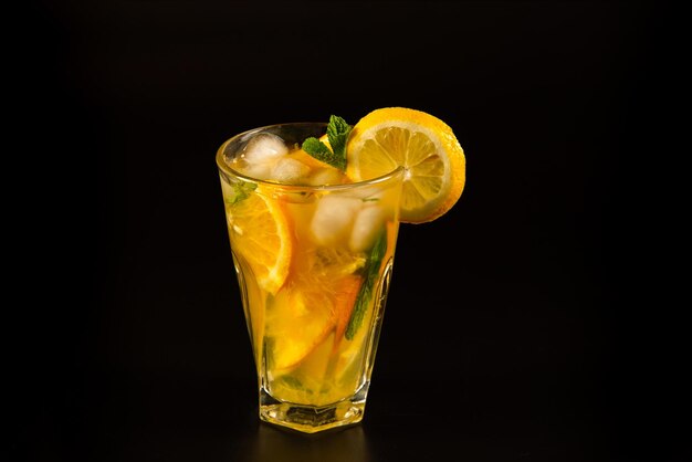 Photo spring or summer refreshing cold cocktail or mocktail with orange and lemon, lemonade, close up