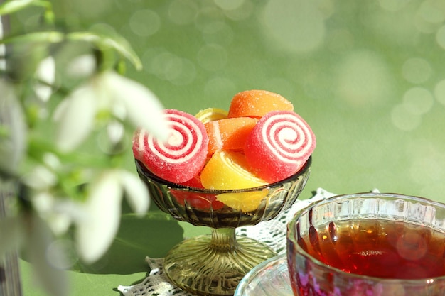 Spring tea party marmalade in a glass vase on a pastel background bokeh closeup