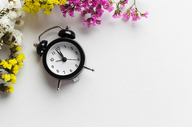 Spring Time Change  with alarm clock and flower branches