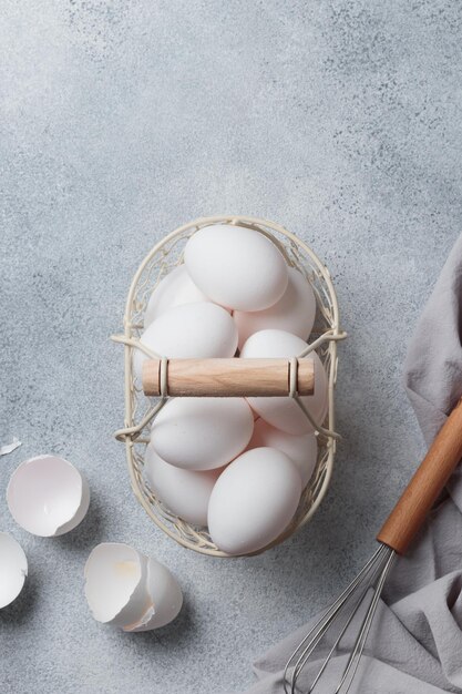 Spring time easter holidays white eggs in a basket gray table