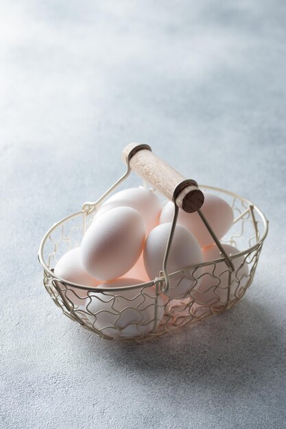 Spring time easter holidays white eggs in a basket gray table