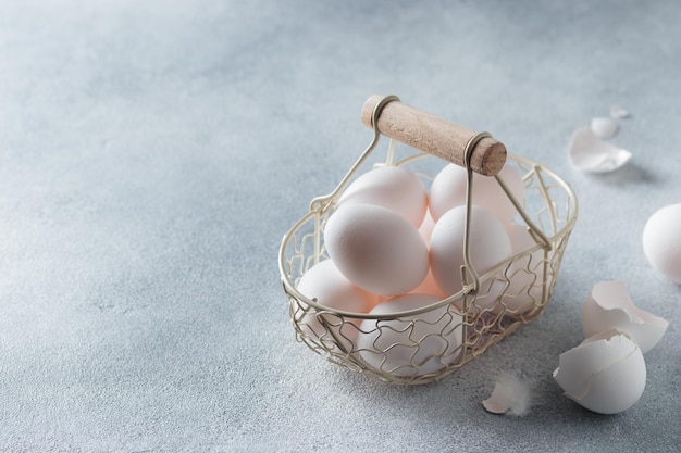 Spring time easter holidays white eggs in a basket gray table