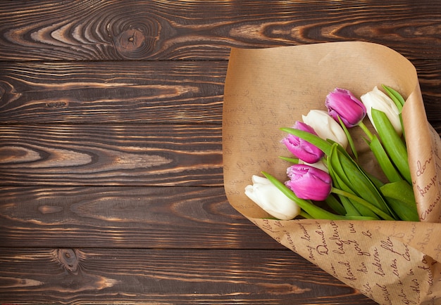 Spring tulips flower on wooden background. Tulip, gardening concept.