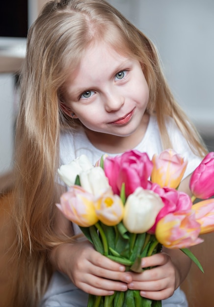 Spring tulips in the hands of a little girl