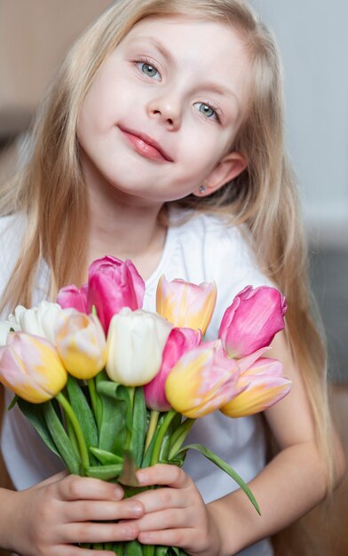 Spring tulips in the hands of a little girl