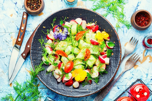 Spring vegetable salad with flowers,top view