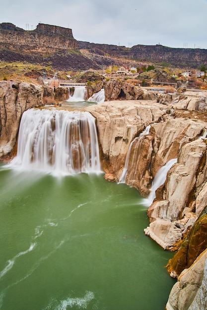 Spring waters at Shoshone Falls in Idaho with tan rocks