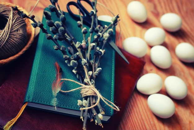 Spring willow and egg on a wooden background