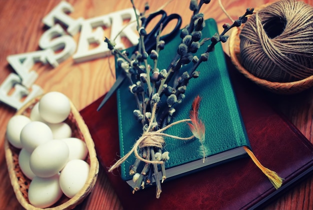 Spring willow and egg on a wooden background