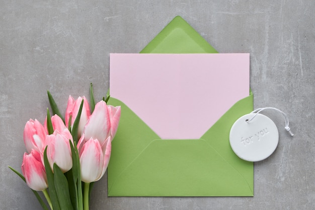 Springtime background with empty gift card in green envelope