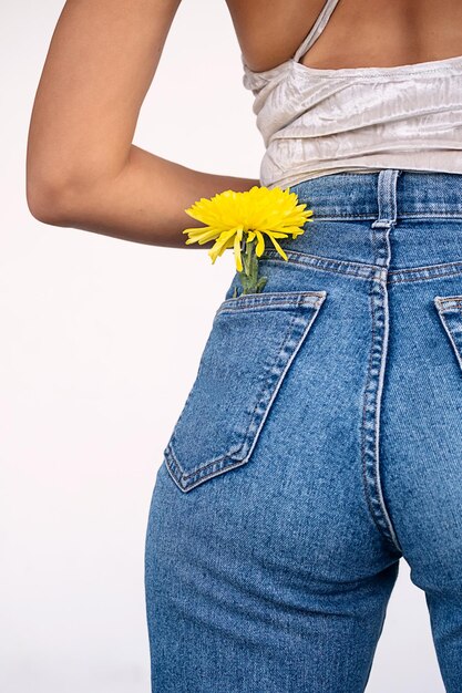 Springtime flower in jeans pocket