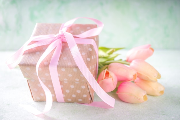 Springtime pink tulips bouquet with gift for Valentine day, Mothers Day or Easter concept