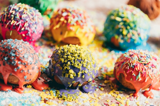 Sprinkled donuts laying on a messy counter