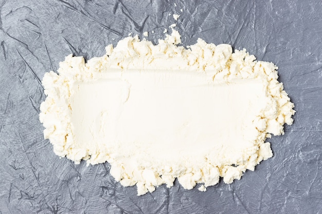 A sprinkled protein powder top view on a gray background.