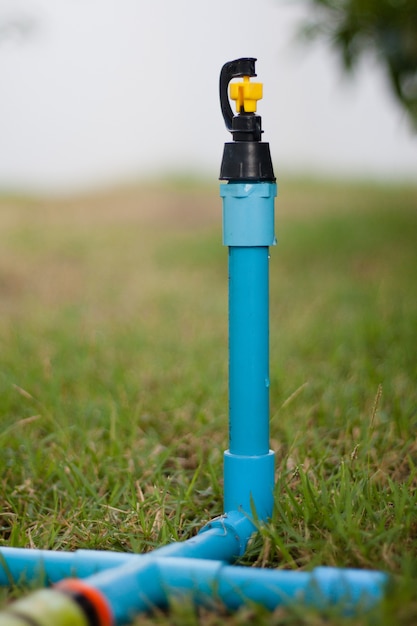 The sprinkler in the garden with blue sky