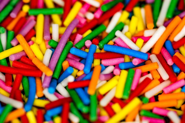 Sprinkling closeup for confectionery multicolored sweet round sticks of vermicelli selective focus