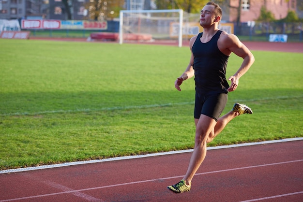 Sprinter leaving starting blocks on the running track. Explosive start.