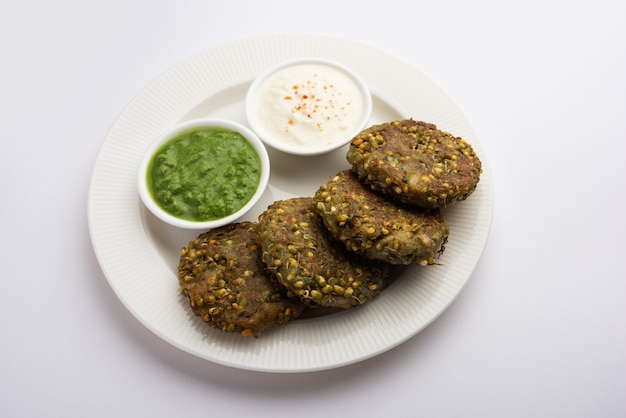 Sprouted moong dal tikki or patties is a healthy snack from India served with green chutney and curd