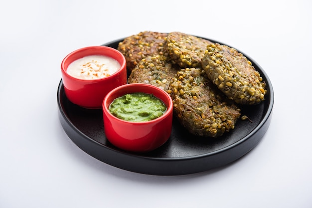 Sprouted moong dal tikki or patties is a healthy snack from India served with green chutney and curd