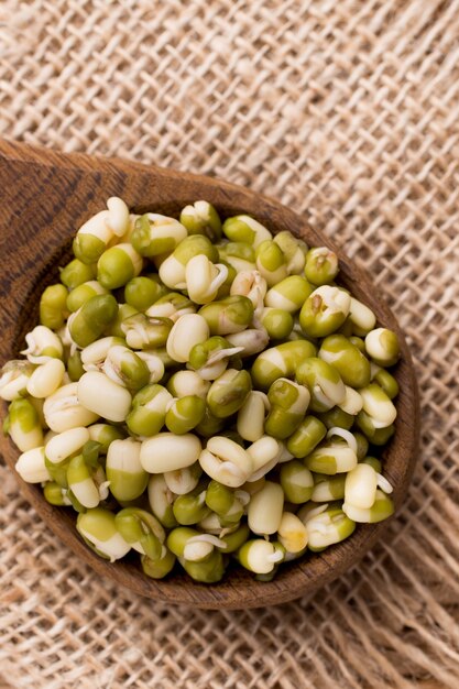 Sprouts to the heart of the bowl and on a wooden table.