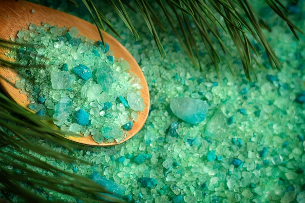 Spruce bath salt on a wooden background Spruce branches in the background