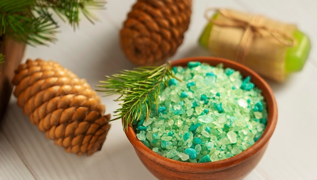 Spruce bath salt on a wooden background Spruce branches in the background