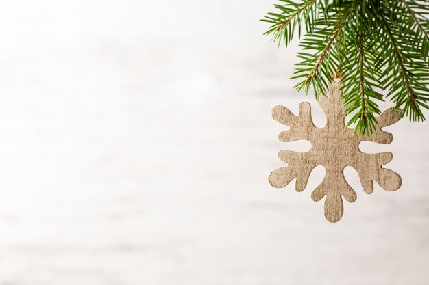 Spruce branch with Christmas decorations on a gray background.