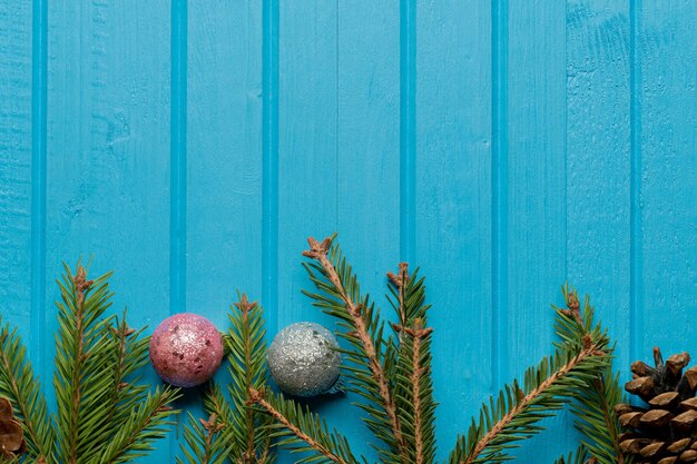 spruce branches on blue wooden table with copy space