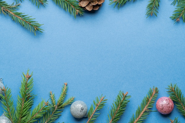 spruce branches and Christmas tree toys on blue