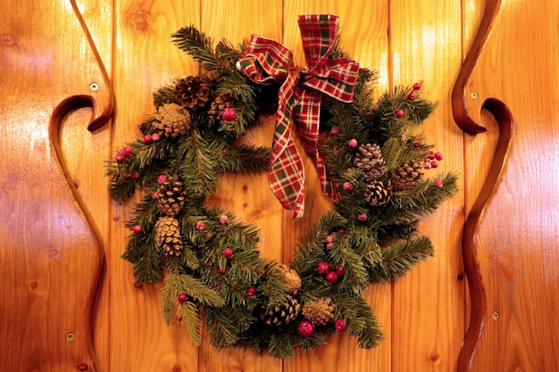 A spruce Christmas wreath hangs on the door Preparing for the New Year