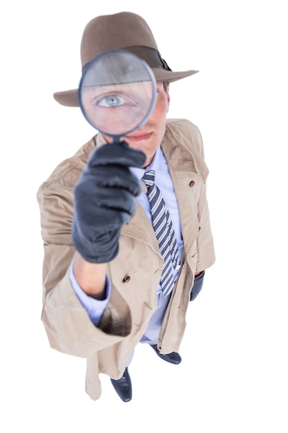 Spy looking through magnifier