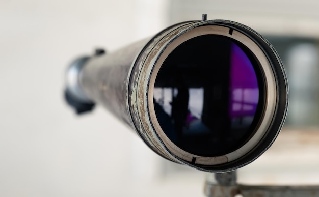 Photo spyglass in the shooting range to watch the target hit the shooting range instructor looks