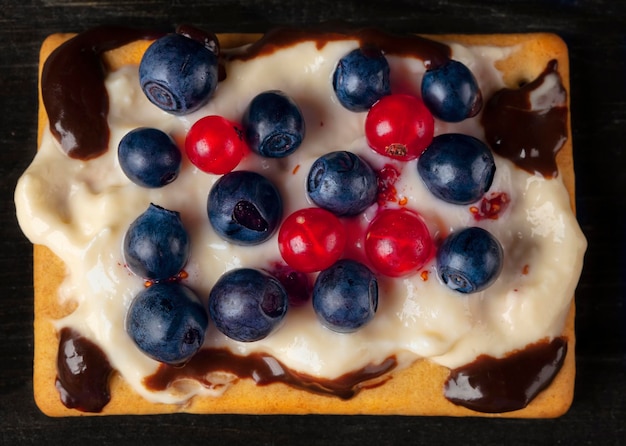 Square berry dessert for a buffet with blueberries and currants Beautiful healthy cake