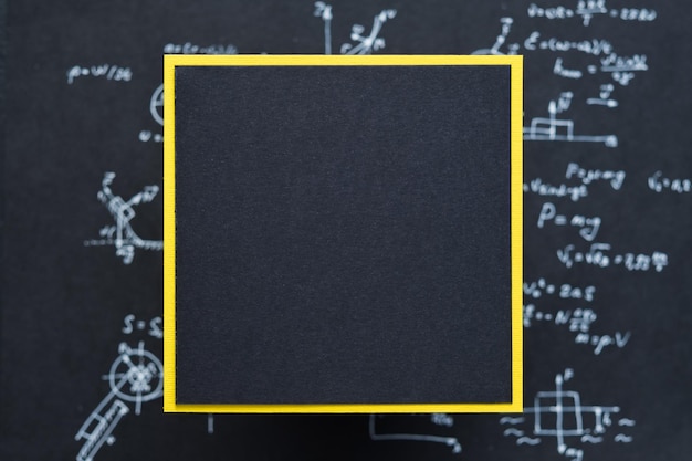 Square blank black paper with space for text yellow contrast frame blurred background with science formula and equation