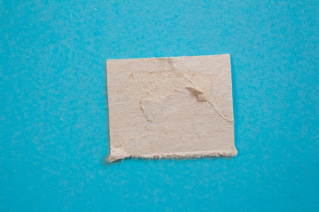 Photo a square of brown paper with a hole in it that says'paper'on it