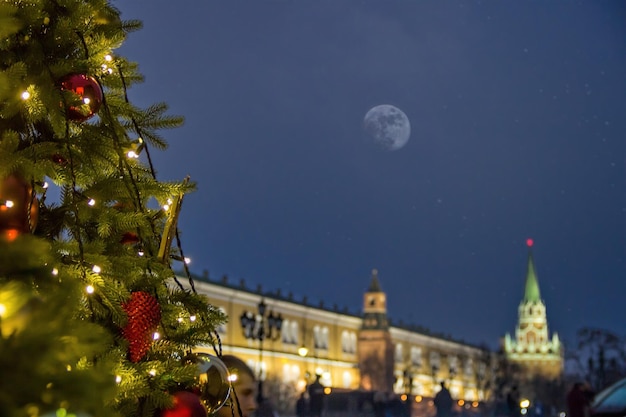 In the square a christmas tree glows decorated with balls and\
beautiful christmas toys closeup