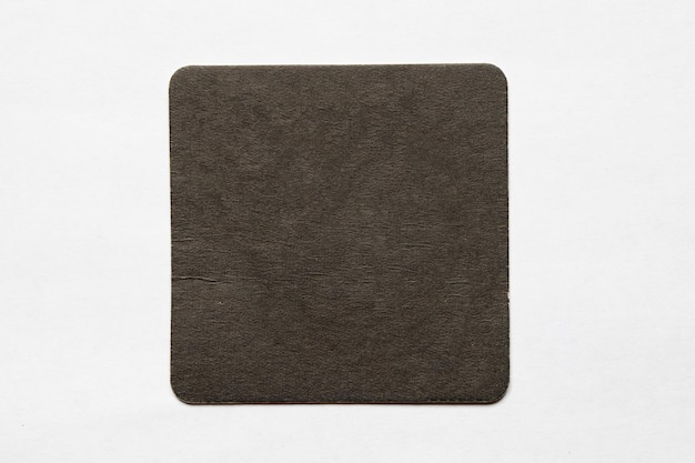 Photo a square coaster with a dark gray color on it