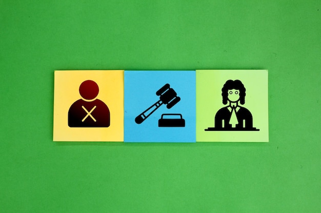 square colored paper with three icons of offender judge and lawyer the concept of judicial procedu