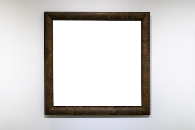 Square dark brown picture frame on white wall