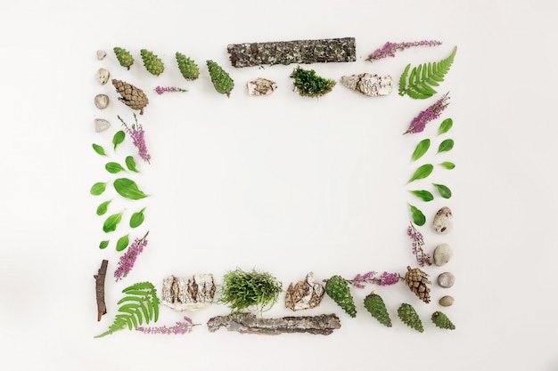 Square frame, natural layout of leaves, stones and wood